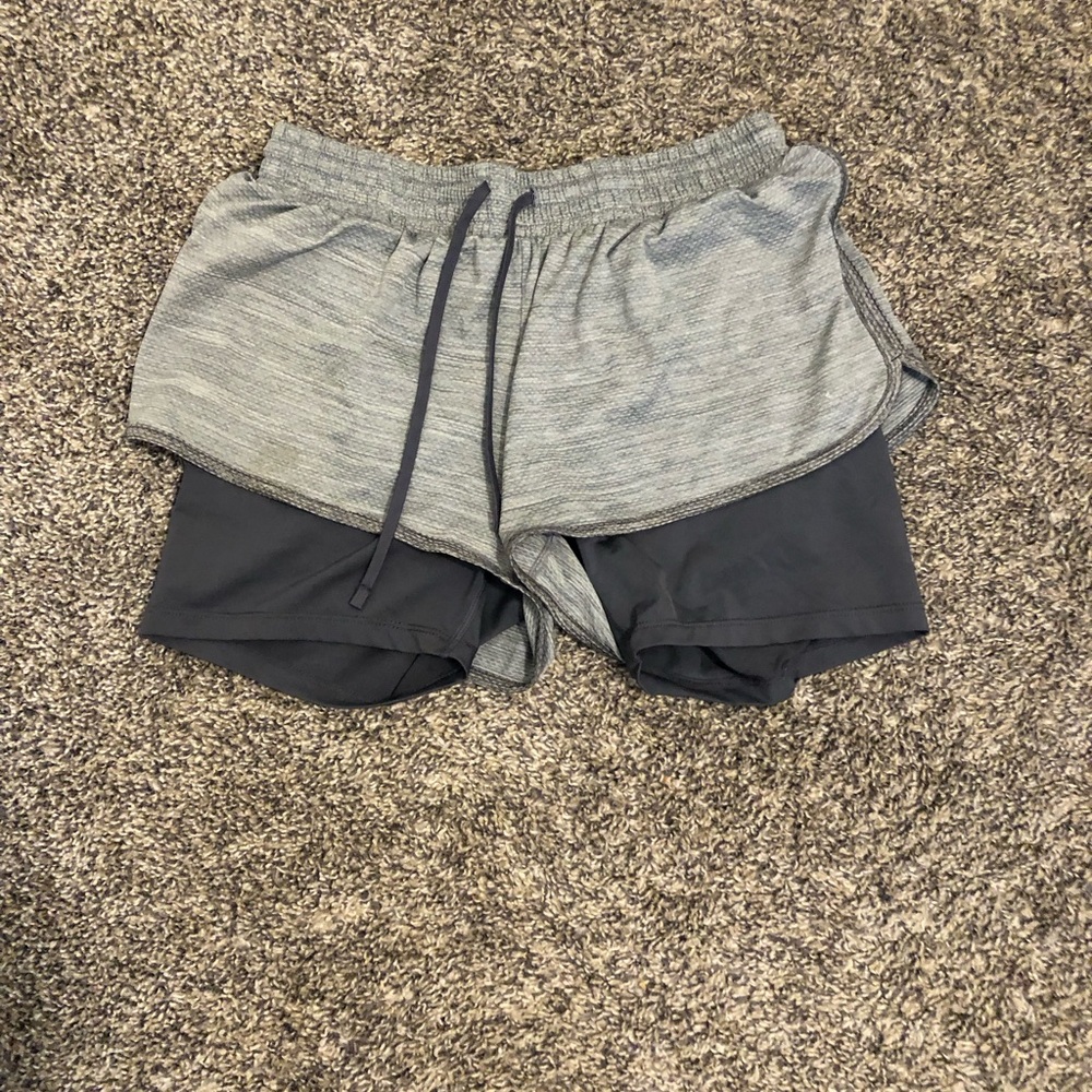 Grey athletic shorts either under tight shorts